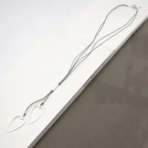 Elongated twin heart pendants on long multi leather necklace