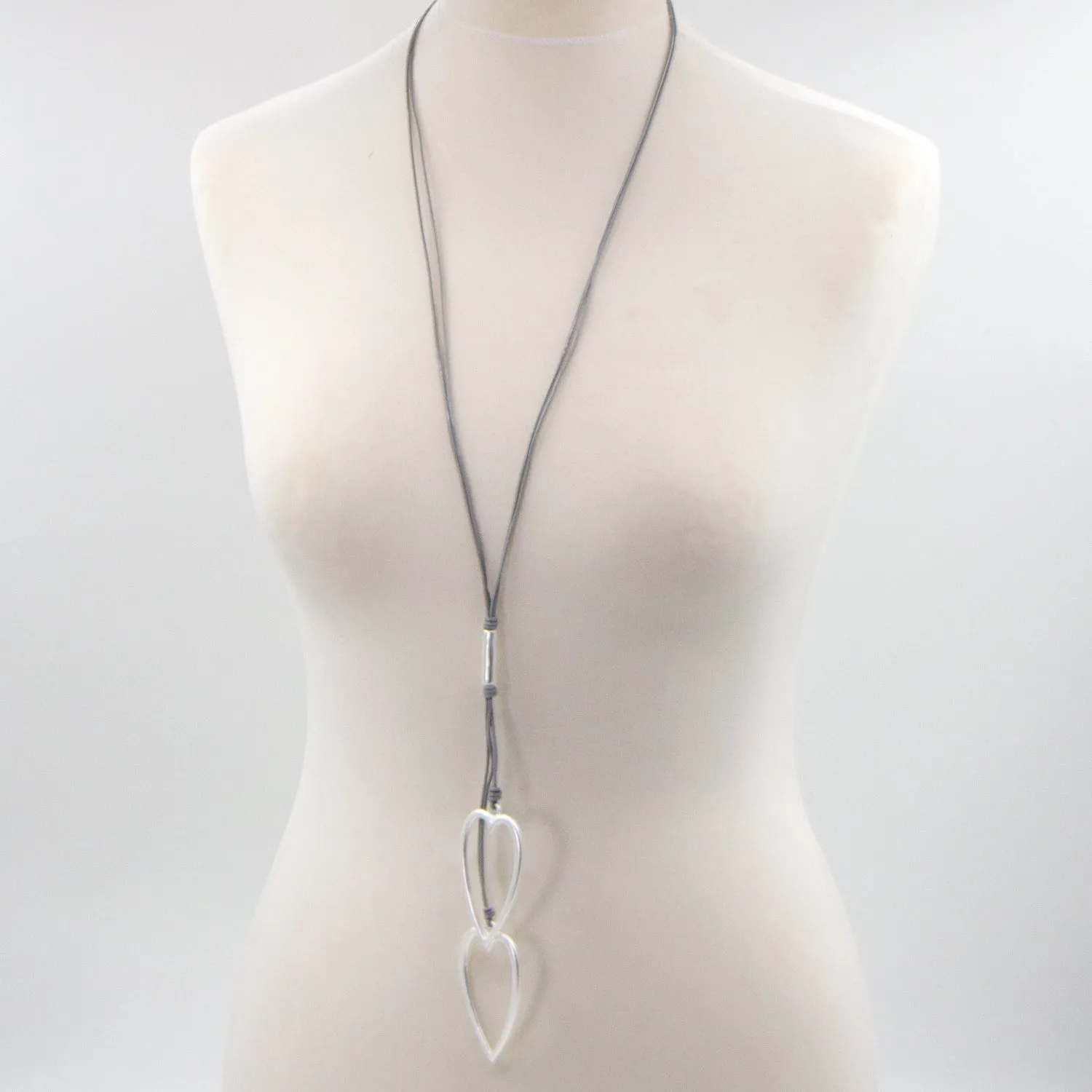 Elongated twin heart pendants on long multi leather necklace